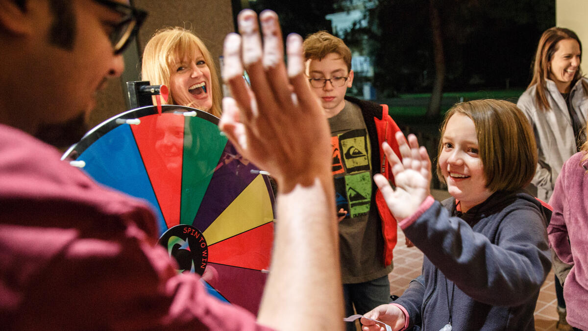 Prize Wheel and Contestants High Fiving