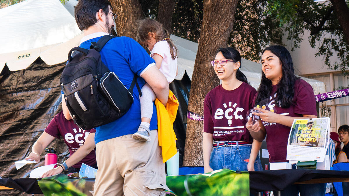 Students interacting with child and parent