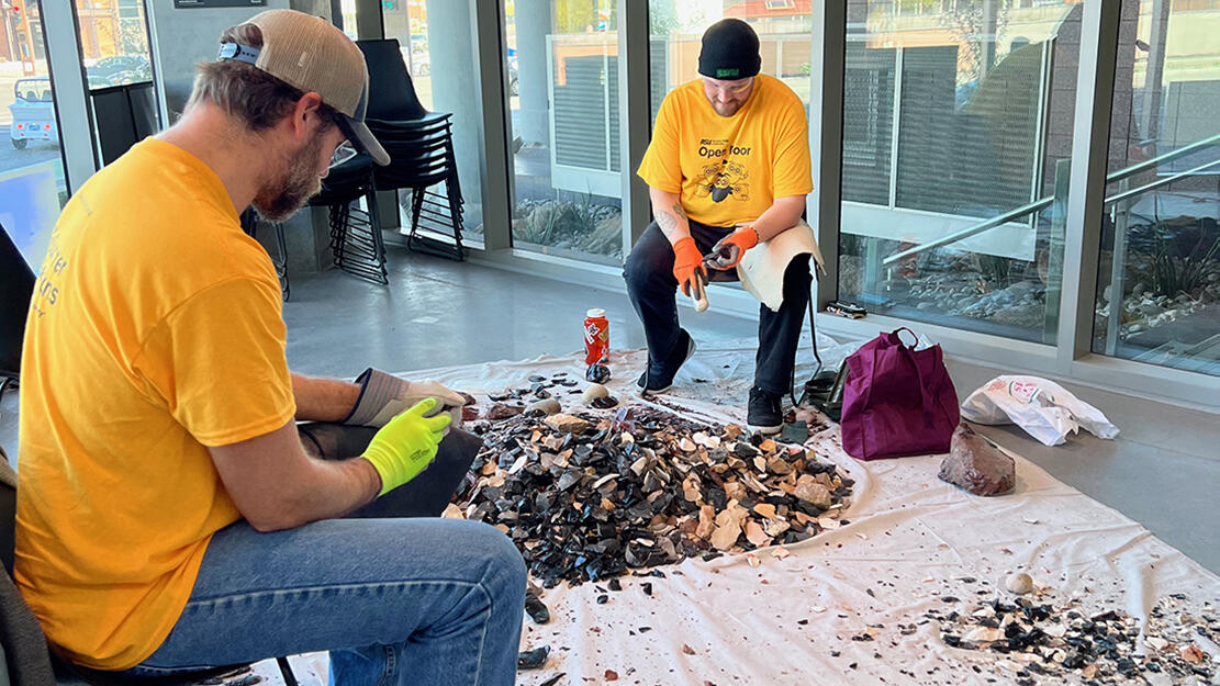 Two men flintknapping