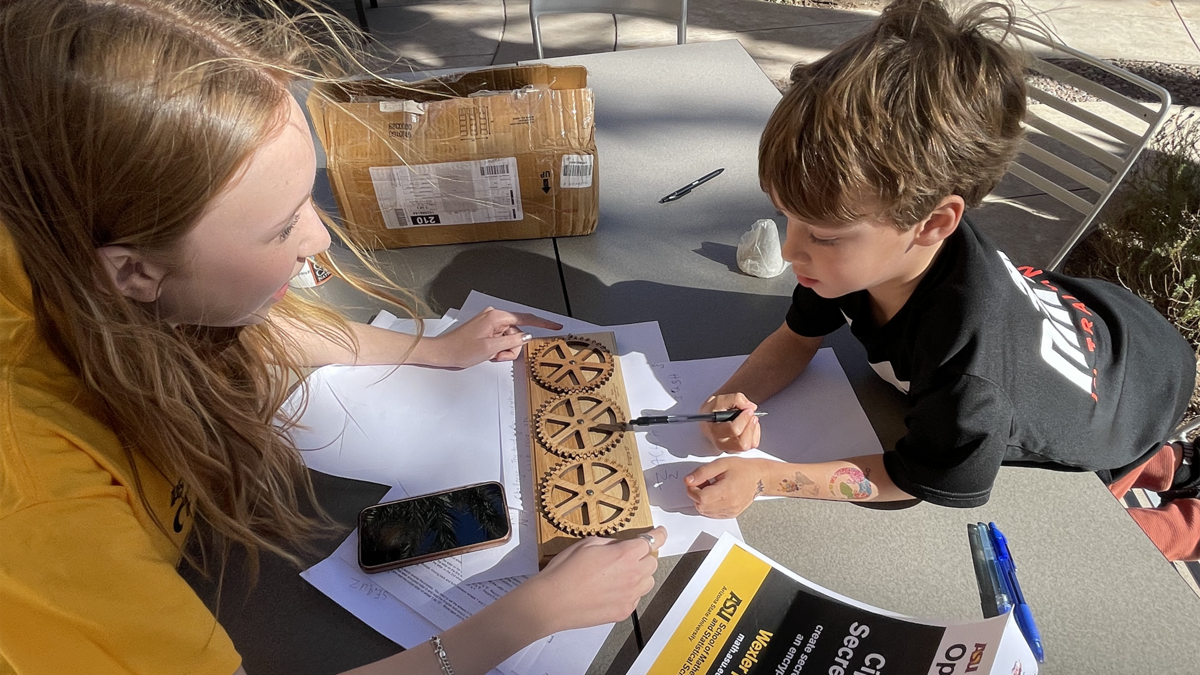 Young boy learning to encrypt a secret message.