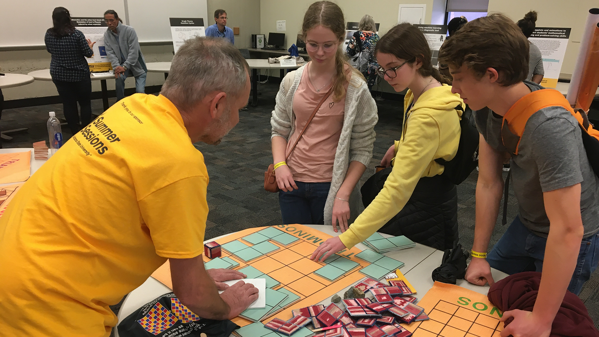 Students learning to solve a tiling puzzle.